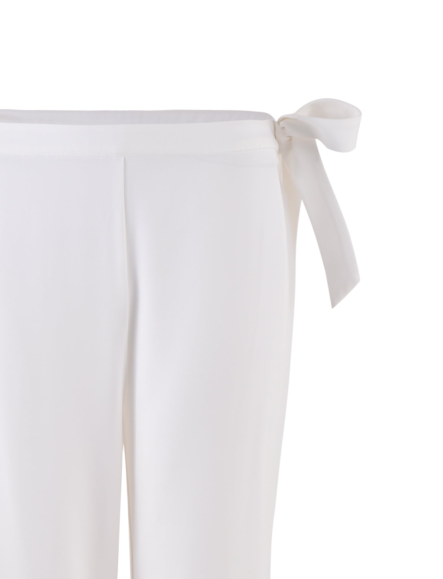 Close-up of the TRISTAN PANT - WHITE by TIGERMIST, featuring a smooth fabric and a side tie detail at the waist. The tie creates a bow on the right side for an elegant finish.