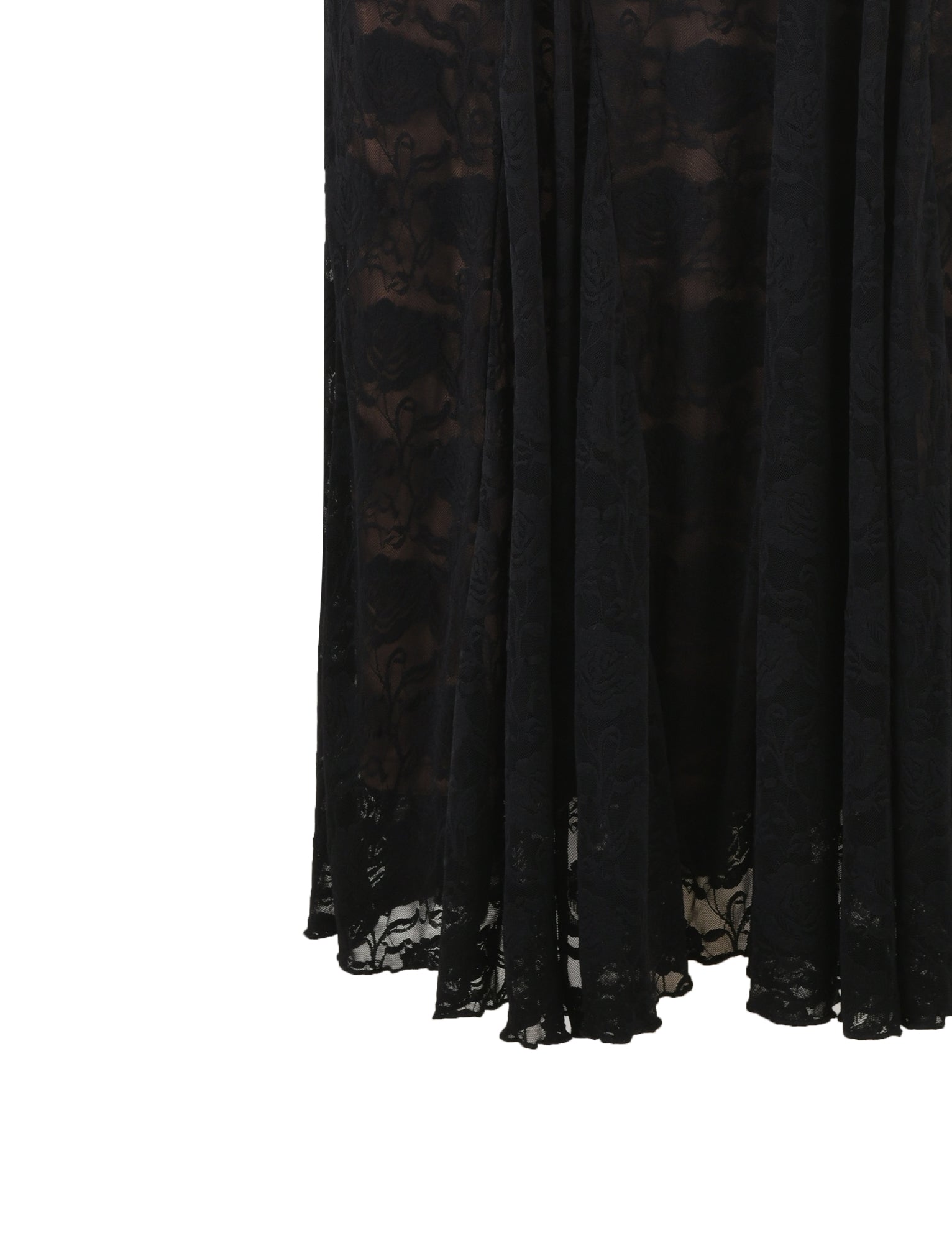 A close-up of the ISADORA SKIRT - BLACK : LACE from TIGERMIST, showcasing its intricate floral pattern. The slightly sheer, black lace fabric reveals the bottom portion of this draped skirt, which features a scalloped hemline.