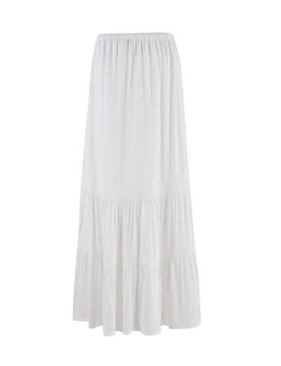 The PHILLIPA SKIRT - WHITE from the TIGERMIST collection is an ankle-length, A-line skirt featuring a tiered design. It boasts an elastic waistband and is crafted from a flowing, lightweight fabric that ensures a comfortable and relaxed fit.