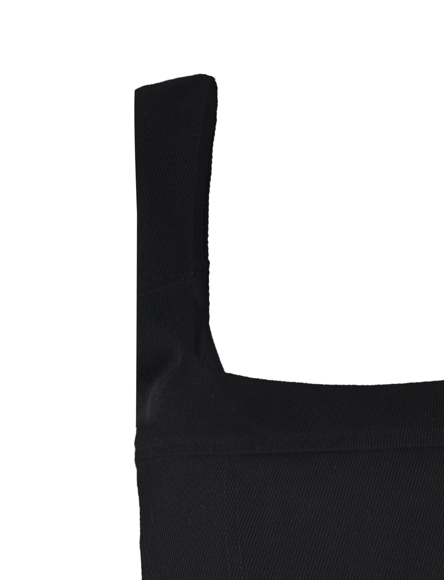 Close-up of the shoulder strap and neckline of a black, sleeveless Sullivan Top by Tigermist on a white background. The fabric features a ribbed texture, with the wide, rectangular strap seamlessly connecting to the bodice.