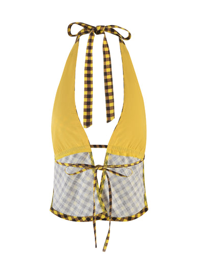 The NICOLA TOP - YELLOW : CHECK by Tiger Mist features a mix of yellow, black, and white checkered patterns. This halter top ties at the neck and back with matching checkered straps and showcases yellow fabric on the upper section along with a light plaid design on the lower section.