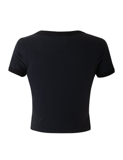 Back view of the BILLIE TEE - BLACK by TIGERMIST. This black short-sleeved crop top features a crew neckline and a fitted silhouette, crafted from plain fabric with no visible designs or logos. The sleeves and hem are neatly hemmed.