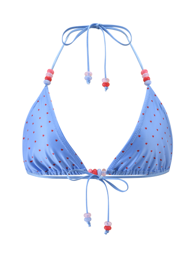 The TIGERMIST FINLEA BIKINI TOP - BLUE HEART POLKA DOT features a blue triangle design with red heart polka dots and adjustable neck and back ties, detailed with pink and red bead accents.