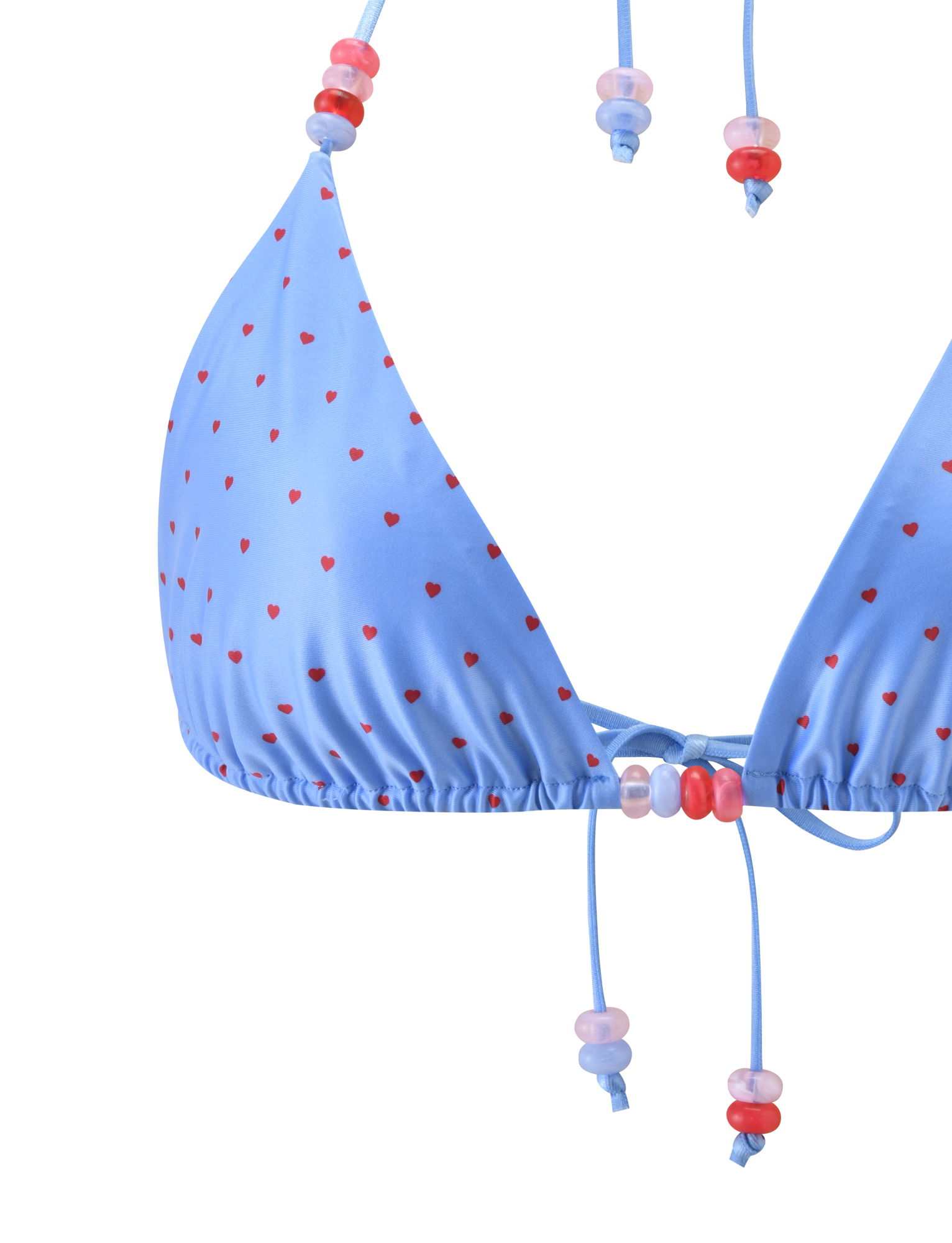Close-up of the TIGERMIST FINLEA BIKINI TOP - BLUE HEART POLKA DOT, featuring a blue triangle design with heart polka dots and pink and red plastic beads on the halter neck straps and ties.