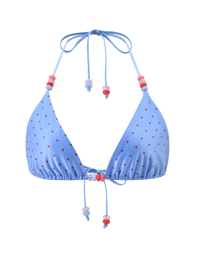 The FINLEA BIKINI TOP by TIGERMIST features a light blue triangle design with red heart polka dots, an adjustable halter neck and front ties adorned with pink and purple beads.