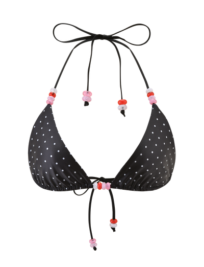 The FINLEA BIKINI TOP - POLKA DOT BLACK CREAM by TIGERMIST features a black polka dot triangle design with adjustable halter neck and back ties, accented with playful pink and red plastic beads.