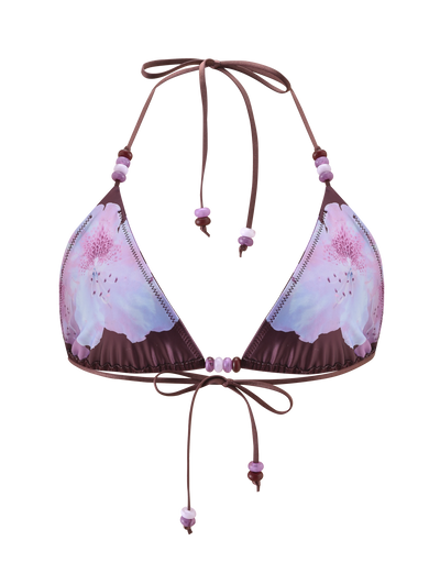 The FINLEA BIKINI TOP - ZEN FLORAL by TIGERMIST features a purple floral print with pink and light purple flowers, a halter neck, and beaded strap accents. Displayed on a plain white background.