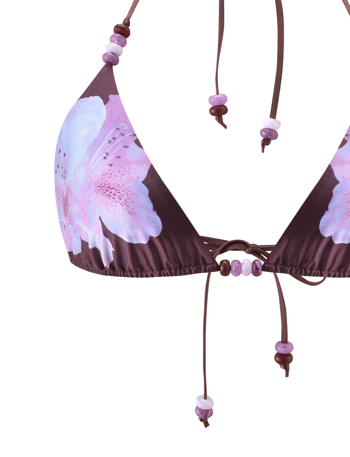 The FINLEA BIKINI TOP - ZEN FLORAL by TIGERMIST features a brown triangle design with pink and purple floral prints, finished with beaded purple and white strings.