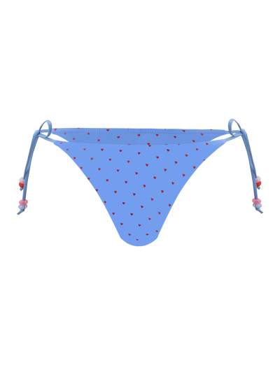 The TIGERMIST FINLEA BIKINI BOTTOM - BLUE HEART POLKA DOT has a cheeky cut, adjustable side ties, and is designed with playful blue heart polka dots on a light background.