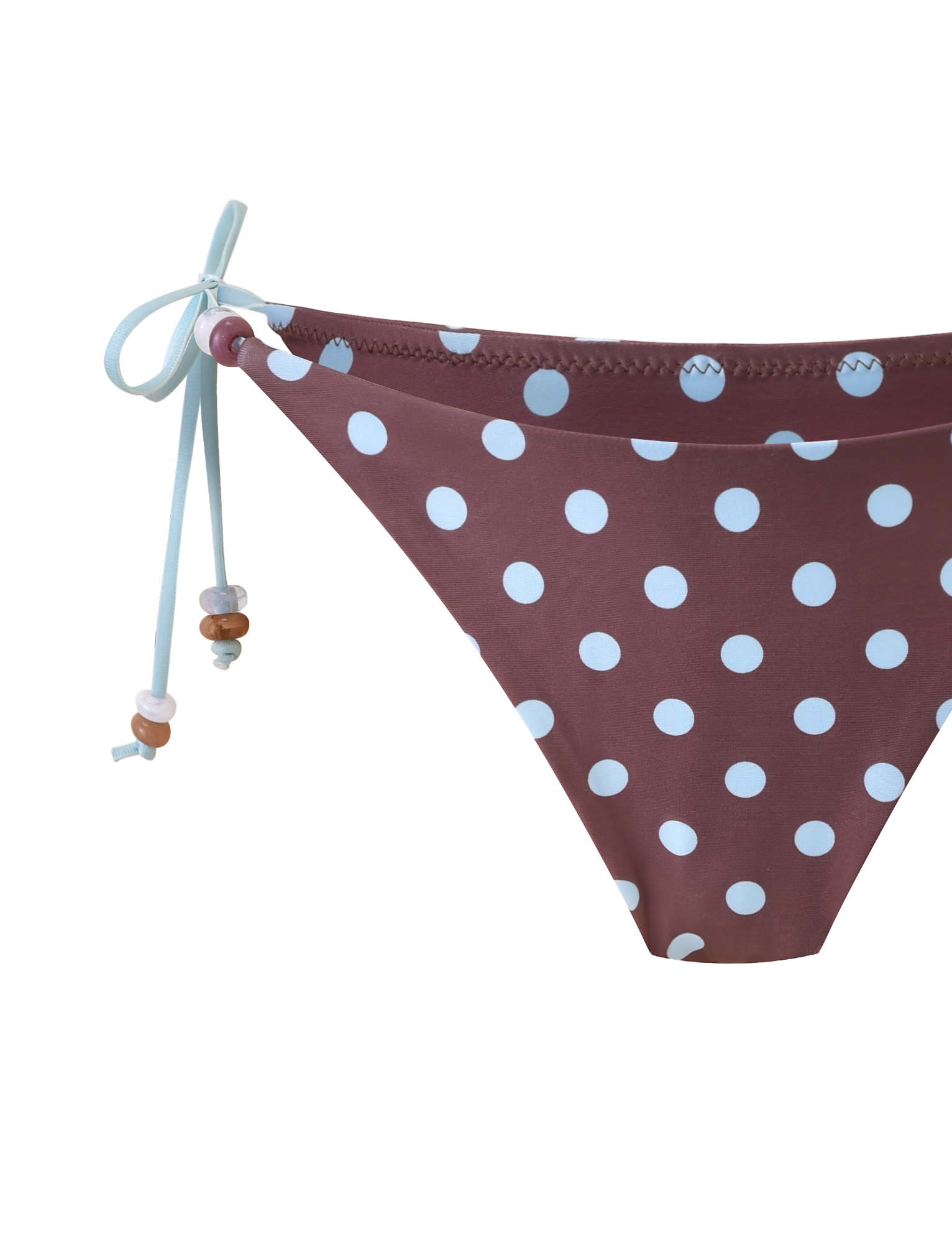 The FINLEA BIKINI BOTTOM by TIGERMIST features a brown and blue polka dot pattern with light blue side ties accented by small beads, creating a playful, cheeky swim look.