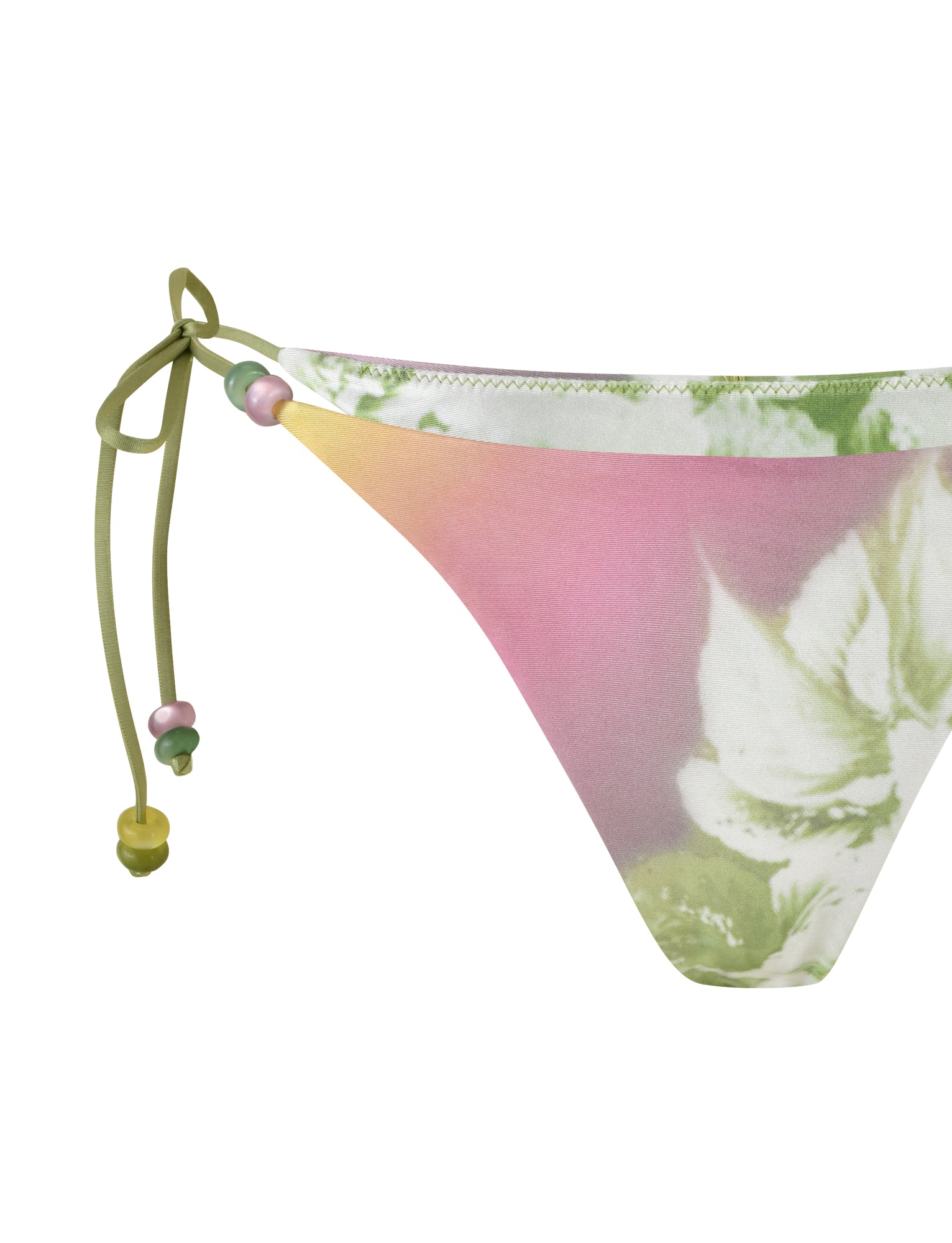 A close-up of the TIGERMIST FINLEA BIKINI BOTTOM in a green floral stripe pattern showcases its playful pastel gradient that transitions from green to pink. This cheeky bikini bottom features charming side ties adorned with small decorative beads in green, pink, and yellow.