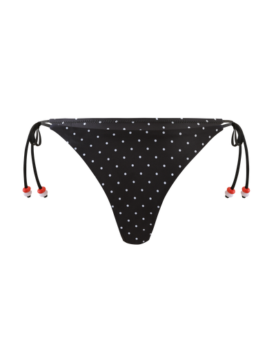 The FINLEA BIKINI BOTTOM - POLKA DOT BLACK CREAM by TIGERMIST features cheeky coverage, adjustable tie sides with small red bead accents, and is shown on a plain white background.