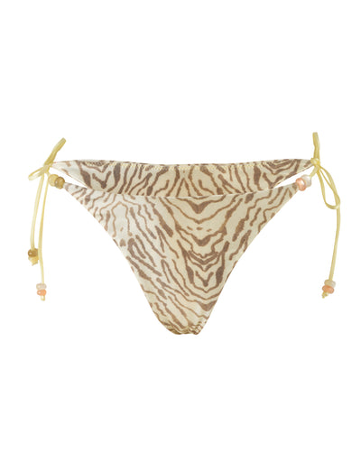 The FINLEA BIKINI BOTTOM - YELLOW : ZEBRA by TIGERMIST is a cheeky bikini cut bottom featuring a zebra stripe pattern in shades of brown and cream. This swimsuit boasts yellow side ties adorned with small beads and high-stretch fabric for a comfortable fit. The slightly textured fabric adds depth, while the symmetrical design ensures a flattering look.