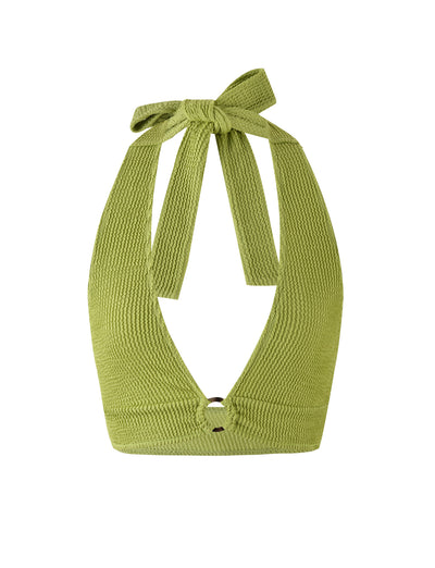 The NEERA TOP - GREEN by TIGERMIST is a lime green halter top crafted from textured, ribbed fabric. It boasts a deep V-neckline and fastens with a bow knot at the back of the neck. This sleeveless top has a slightly cropped length.