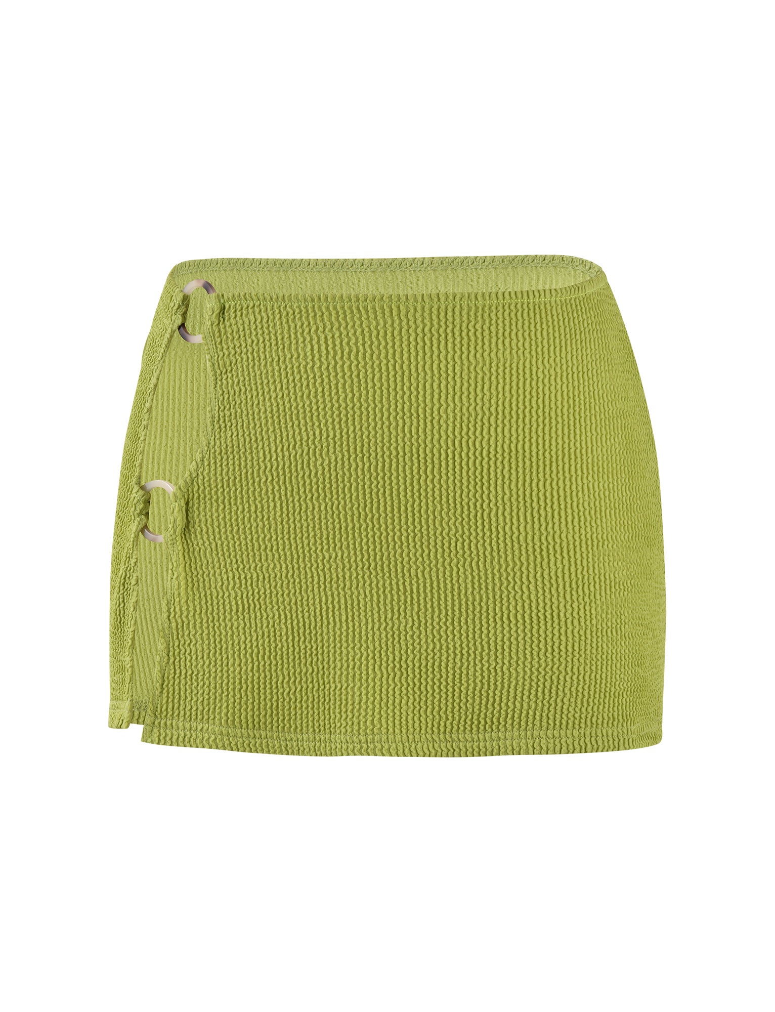 The NEERA MINI SKIRT - GREEN : LIME GREEN from TIGERMIST is a stylish piece characterized by its textured knit material. It features a slight wrap design on the left side, secured with two silver rings and adorned with a fringe detail that hangs down, offering both simplicity and elegance.
