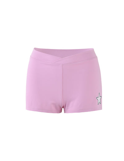 Introducing the DELANEY SHORT - PINK by TIGERMIST, featuring a pale pink tone and a V-shaped, low-rise waistband. These bodycon shorts come adorned with a subtle white star logo on one leg. Isolated against a white background, they strike the perfect balance between comfort and style.