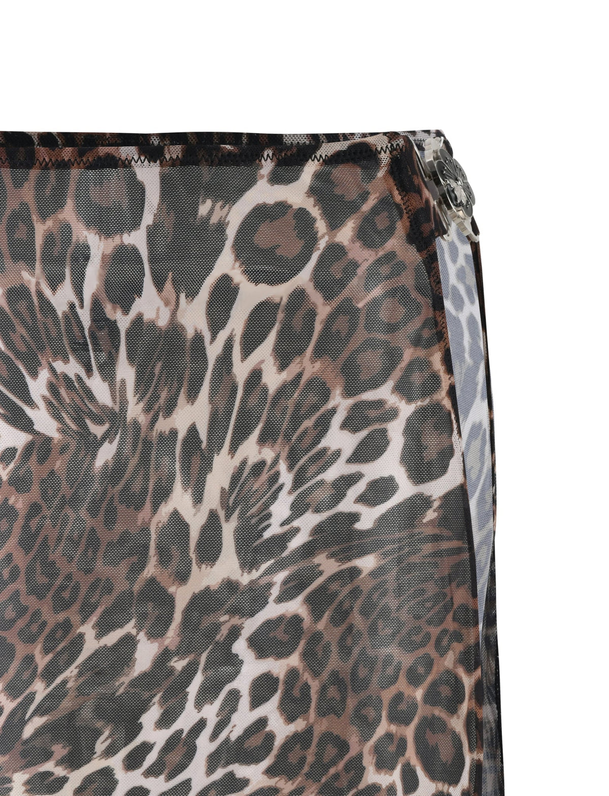 Close-up of the Cynthia Mini Mesh Skirt from TIGERMIST, featuring a leopard print pattern in shades of brown, black, and white. The fabric drapes at the top right edge and is stitched with a visible hem, suggesting this chic piece might easily complement any wardrobe.