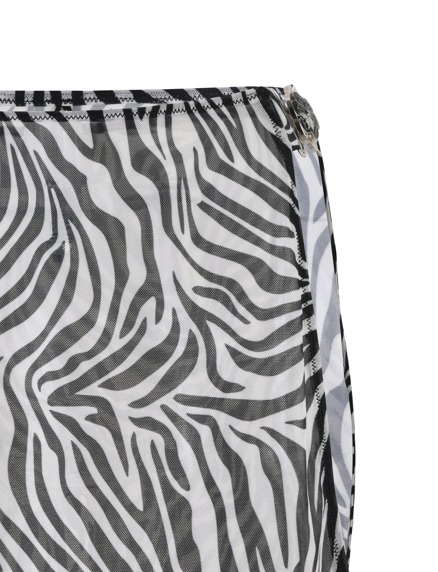 Close-up of the CYNTHIA MINI MESH SKIRT - BLACK : ZEBRA fabric by TIGERMIST, showcasing a black and white zebra print pattern. The skirt features stripes that mimic a zebra's coat, with visible black stitching along the edge and a partially visible metal zipper on the right side.