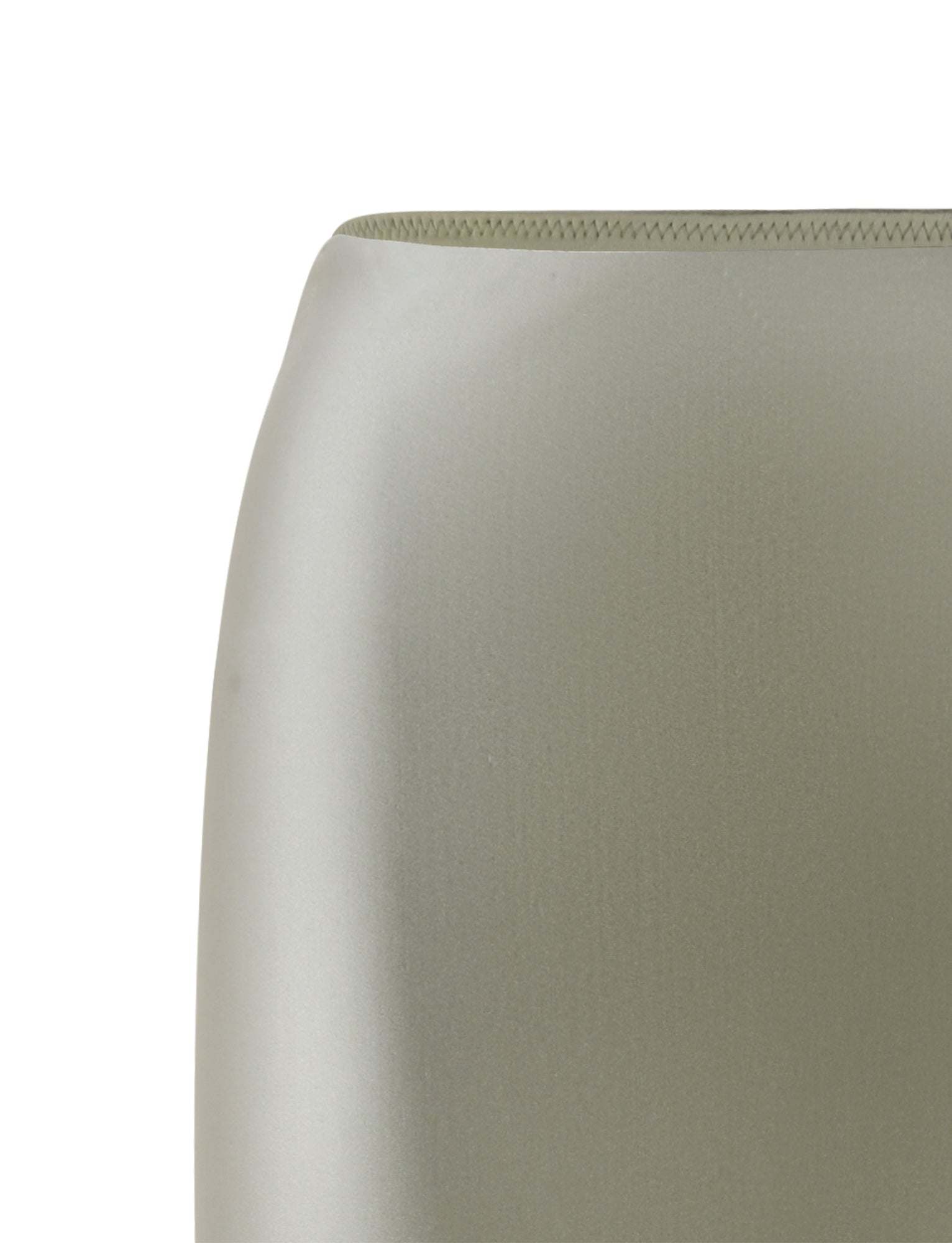 Close-up of the THESSALY SKIRT in matcha green from TIGERMIST, showcasing its sleek and modern design. The smooth texture and faint seam on the top edge suggest a high-quality, manufactured item. The background is plain and not visible.