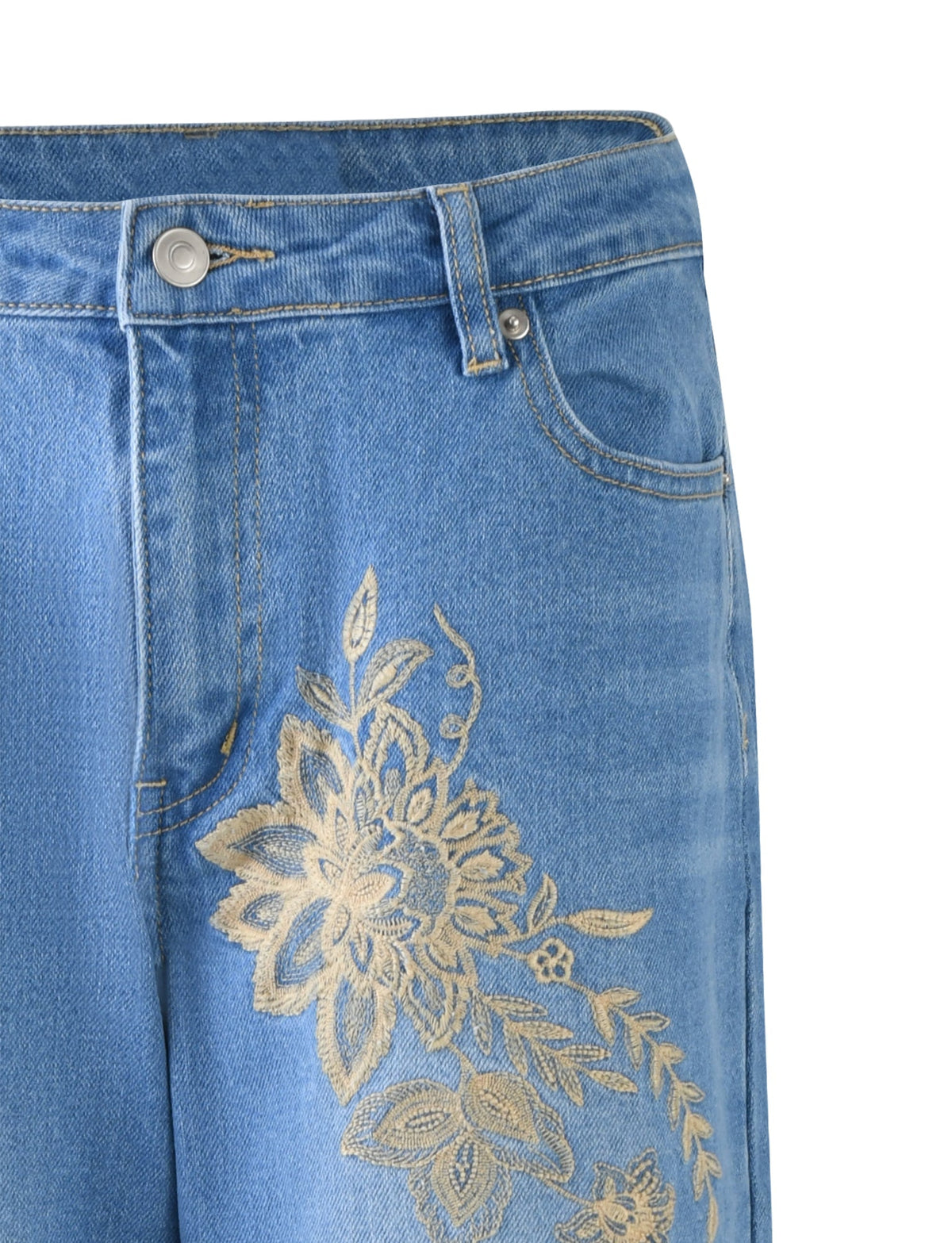 Close-up of a pair of VEGA JEANS in mid blue denim from TIGERMIST, featuring an intricate gold floral embroidery pattern on the upper left thigh area. The jeans have a button and zipper closure, along with standard belt loops and pockets.