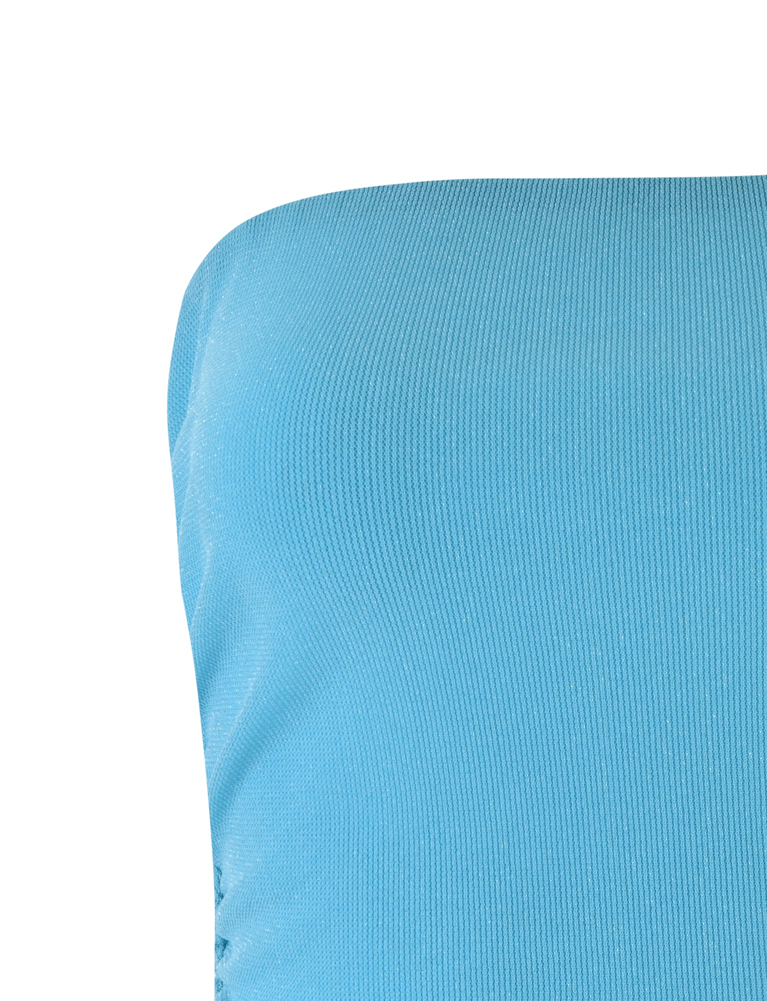 Close-up of a blue fabric with a ribbed texture, likely part of the HARRIETT TUBE TOP - BLUE SPARKLE by TIGERMIST. The material occupies the right side of the frame, showcasing its smooth and continuous surface against a white background.