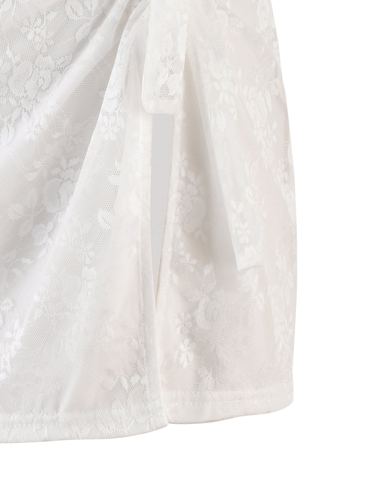 A close-up of the FLORIAN SKIRT - WHITE : LACE by TIGERMIST, showcasing its delicate floral lace fabric. The skirt is draped with a section tied into a knot, highlighting the intricate lacework that allows light to pass through its sheer design.