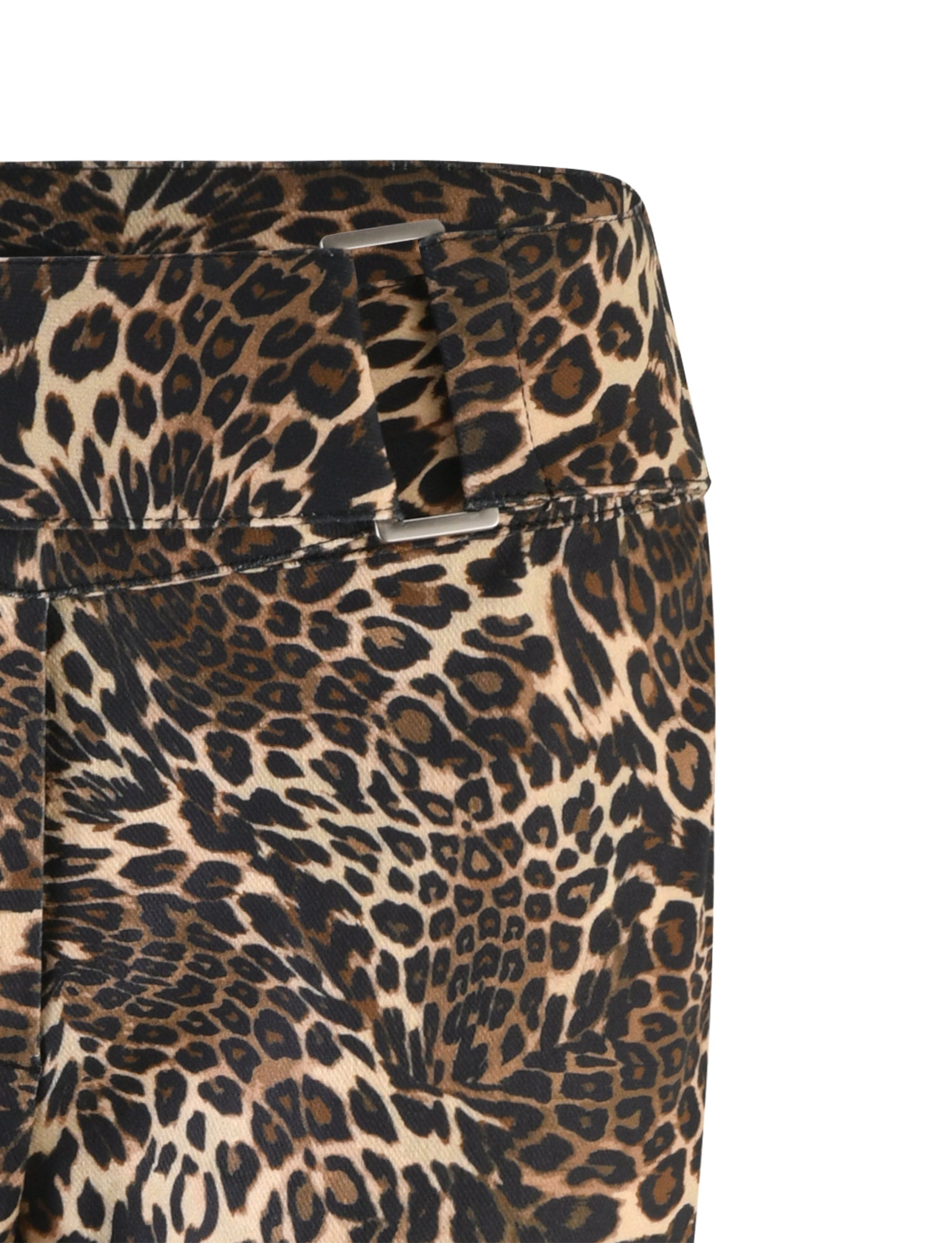 Close-up image of the Vesper Pant - Multi : Leopard by TIGERMIST. The fabric showcases a diverse mix of black, brown, and tan spots resembling a leopard's coat, with part of a waistband visible in the upper portion of the image.