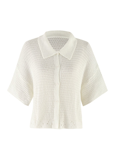 The JANAI TOP - WHITE : CREAM from TIGERMIST is a white, short-sleeved knit cardigan with a textured pattern. It features a button-up front and V-neckline, offering a relaxed, airy appearance with an oversized fit that makes it perfect for layering in warmer weather.