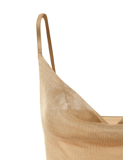 Close-up of the WYNNE TOP - GOLD by TIGERMIST on a beige background. The fabric has a smooth, shiny, and slightly sheer texture, with one visible thin strap over the shoulder. The top appears form-fitting with a cowl neckline.