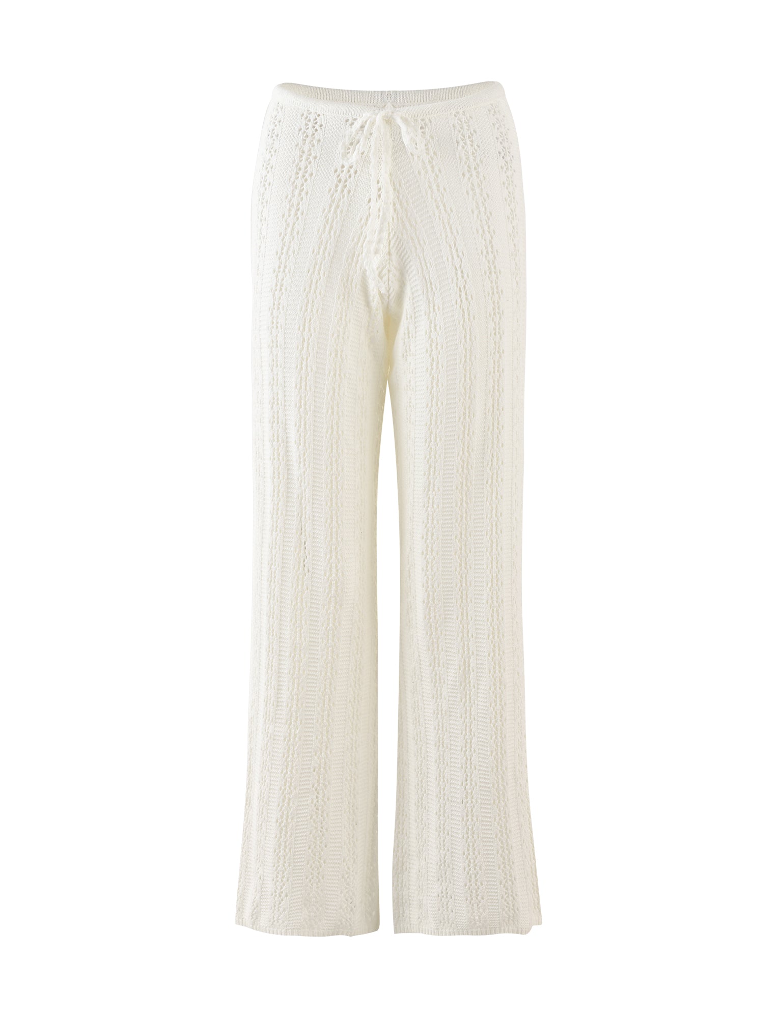 The SANDOR PANT - WHITE from TIGERMIST features a wide-leg design with a drawstring waist. Made from a white, knitted fabric with a subtle vertical cable-knit pattern, these pants offer both texture and a slightly sheer appearance. The hem falls just below the ankles.