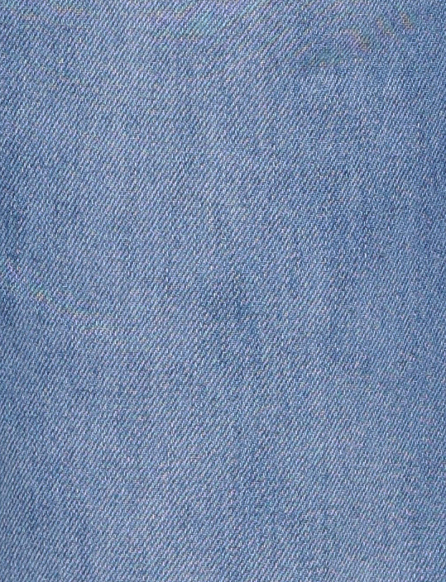 Close-up view of the AVEREE JEAN - BLUE : MID WASH from TIGERMIST, showcasing its light blue denim fabric with a diagonal weave pattern. The texture appears slightly worn, giving it a soft look, and the threads are tightly woven. There are no visible stains, rips, or marks on the fabric.