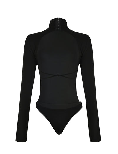 The AKARI BODYSUIT - BLACK by TIGERMIST is a long-sleeve bodysuit with a high collar and zip fastening at the neck. This sleek, minimalist design features a fitted silhouette with a high-waisted bottom section, crafted from smooth and stretchy fabric.