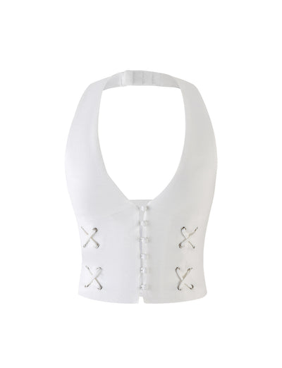 The HALSEY TOP - WHITE : CREAM from TIGERMIST is a white, sleeveless halter top featuring a deep neckline, button closure down the front, and decorative criss-cross lace-up details on each side of the torso. The fabric appears to have a textured finish.