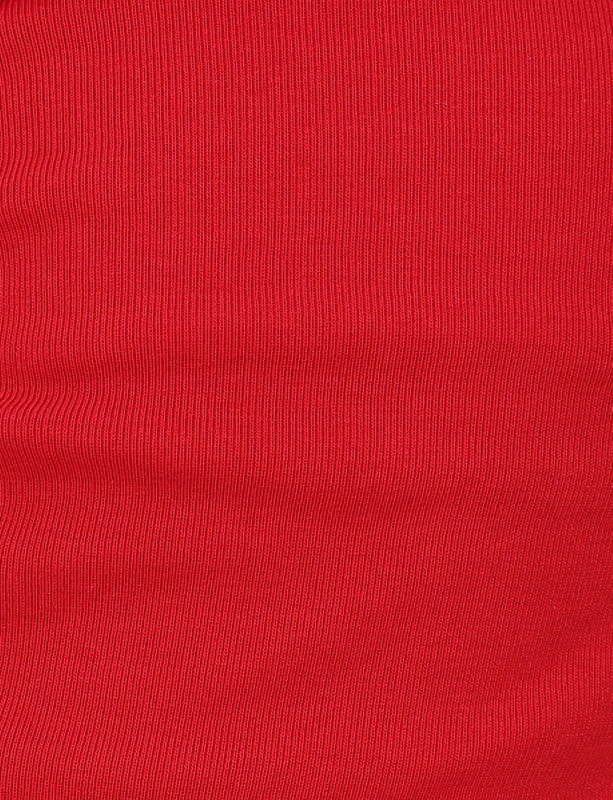 Close-up of the vibrant red textured fabric from the TIGERMIST collection, showcasing fine vertical lines and a subtle ribbed appearance that resembles the KARINA RIB SHORT - RED. The smooth and uniform surface beautifully highlights the rich color and exquisite details of its ribbed design.