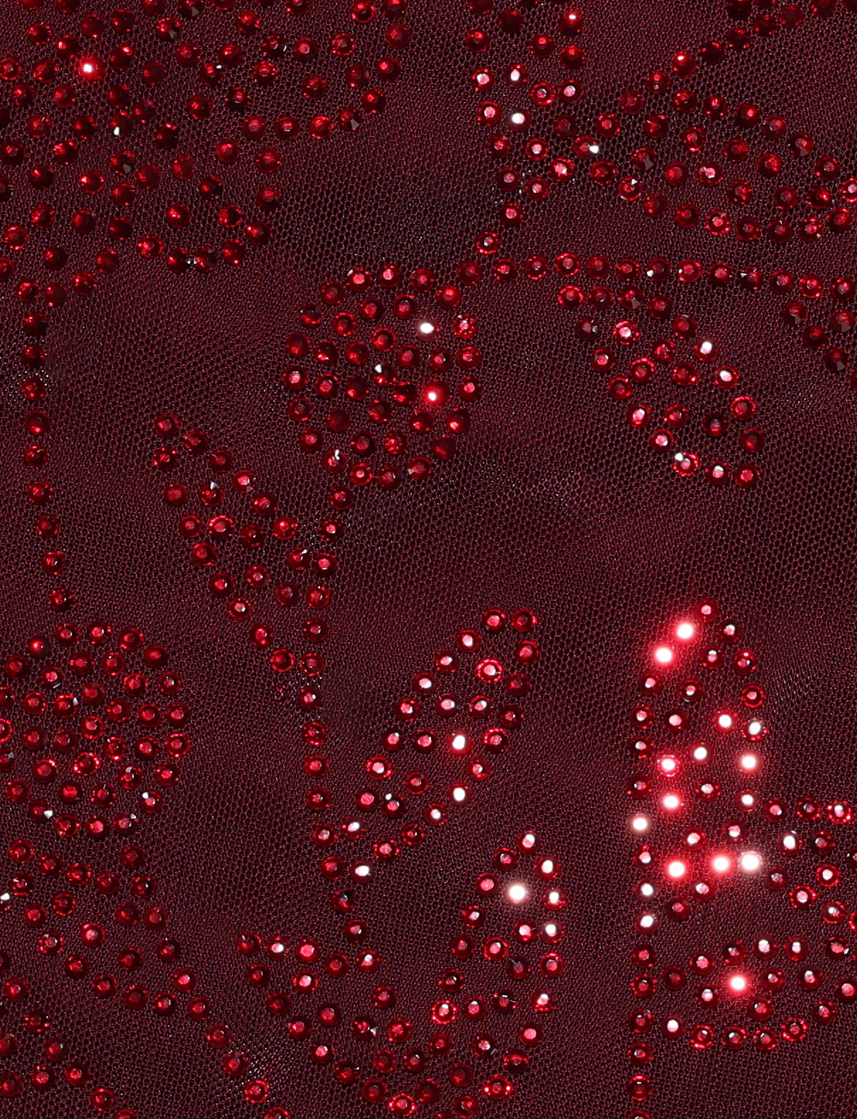 Close-up of deep wine fabric on the TIGERMIST OCTAVIA DRESS, adorned with sparkling red rhinestones in floral patterns that catch the light for a shimmering effect.