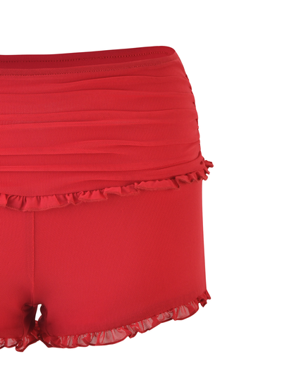 The GINNY SHORT - RED by TIGERMIST features a bodycon fit, high-waisted cherry red design, and ruffle details on the ruched waistband and leg openings, displayed against a white background.