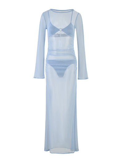 The ALAYNA THREE PIECE MAXI DRESS - BLUE in pale blue by TIGERMIST is displayed. This light blue, sheer, long-sleeved maxi dress features a fitted silhouette and comes with a matching inner set that includes a bralette and high-waisted briefs. The sheer fabric reveals the details of the undergarments beneath.