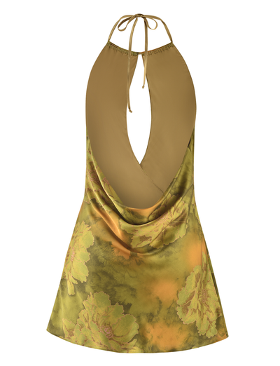 The TIGERMIST MONROE DRESS - GREEN: WATER COLOUR FLORAL features a sleeveless, backless halter neckline with a tie at the neck, a deep V-shaped open back, and a green and yellow floral print.