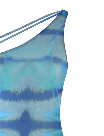 Close-up of the dress's upper section. The design by TIGERMIST, named the TENLEY DRESS - MULTI : ABSTRACT TIE DYE, features a one-shoulder strap and an abstract blue and teal pattern, resembling waves or watercolor strokes with various shades of blue and hints of white.