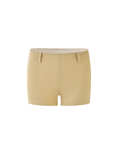 The LYNSEY SHORT - GOLD by TIGERMIST is a pair of high-waisted women's knit shorts featuring a simple design, smooth texture, and belt loops at the waist. These beige shorts have a fitted and stylish appearance, making them suitable for casual or lounge wear.