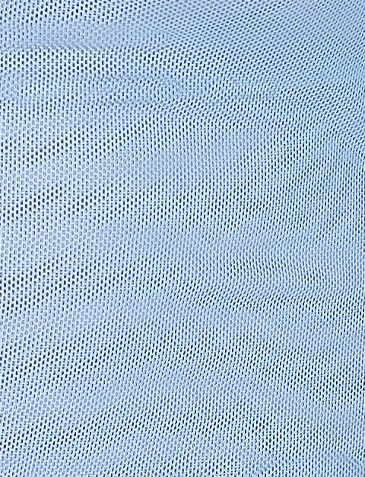 Close-up of the ELVERA TOP - BLUE : GRADIENT FLORAL by TIGERMIST, featuring light gray and white knitted fabric with a repetitive pattern of small, interlocking loops. The texture displays slight waves and shadows, reminiscent of a gradient blue print on a fitted silhouette, adding depth to the soft, woven material.