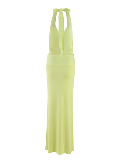 Introducing the MAREE DRESS - GREEN by TIGERMIST: This elegant maxi-length dress boasts a long, sleeveless design in a striking green knit. It features a halter neck with wide straps that tie at the back, and a deep V-back. The halter-style dress flows gracefully with its straight, slightly flared silhouette, perfect for making a statement.