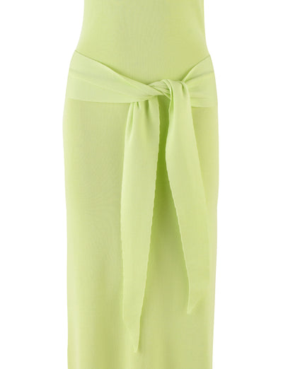 Close-up of a person wearing the MAREE DRESS - GREEN by TIGERMIST, a stunning lime green, halter-style dress that showcases a wide belt elegantly tied in a knot at the waist. The slightly ribbed material provides a textured look, adding dimension. The background is plain and unobtrusive.