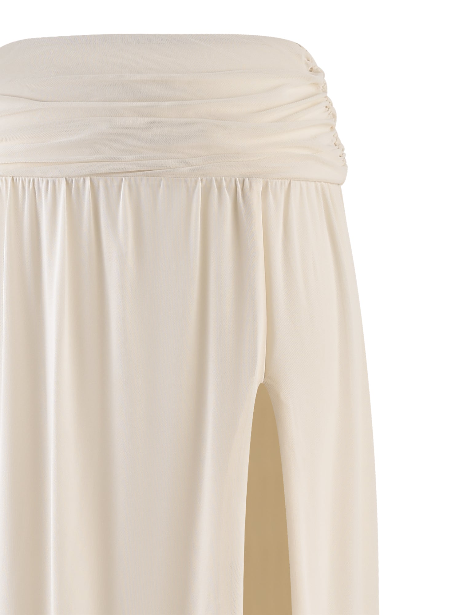 A close-up of a BIRDEE SKIRT - WHITE : CREAM by TIGERMIST featuring a gathered waistband and high slit. The fabric appears soft and slightly drapey, creating an elegant and airy appearance. The skirt's design suggests a comfortable and stylish fit.