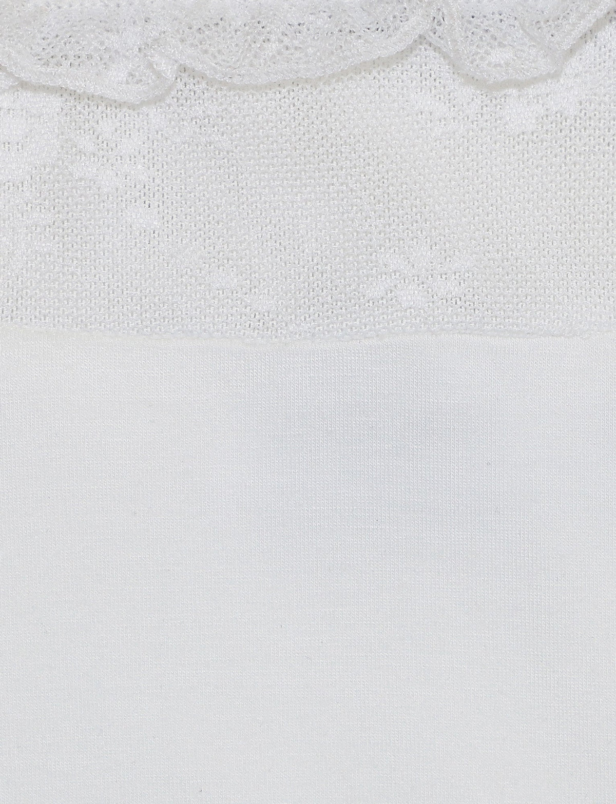 Close-up of the white BENTON TOP by TIGERMIST, showcasing a knitted pattern along the top edge. The knitted section displays small, intricate designs, while the bottom part features a smooth, plain weave. The transition between these two sections is clearly visible.