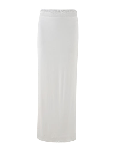The BENTON SKIRT - WHITE by TIGERMIST showcased on a plain white background, is a long, straight maxi skirt extending from the low rise waist to the ankles. It features a smooth and elegant flow complemented by a delicate lace waistband that adds a touch of sophistication.