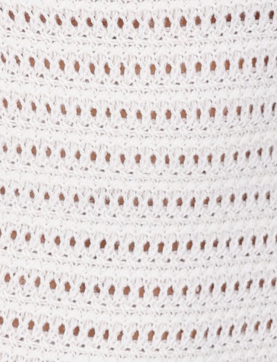 Close-up of the TIGERMIST MARLEIGH DRESS - WHITE featuring rows of evenly spaced, small oval holes. The texture and intricacy of the stitches are clearly visible, highlighting the delicate and detailed craftsmanship typical of a maxi length dress.