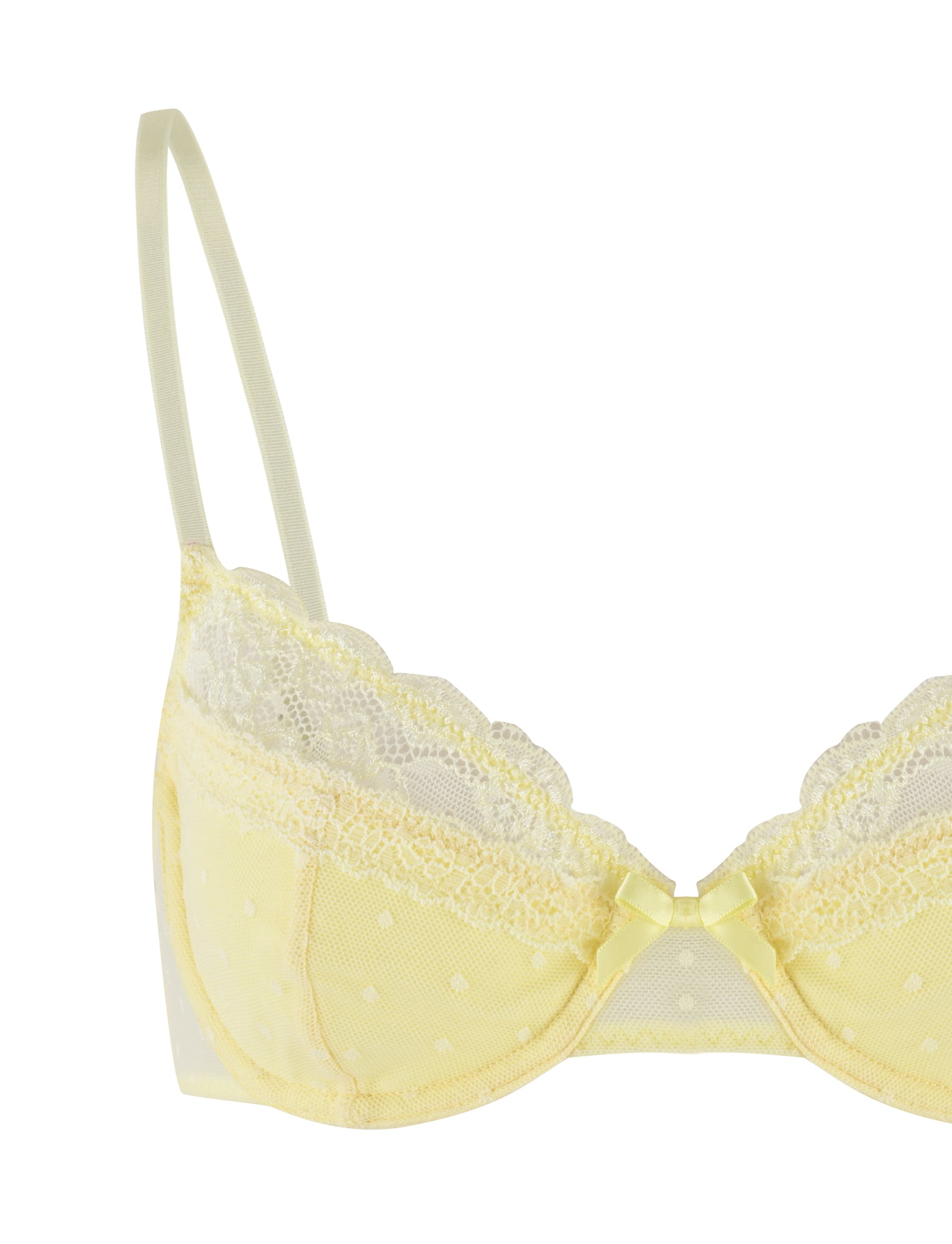 The SHAI SET - YELLOW : LEMON by TIGERMIST features a delicate light yellow bra adorned with small polka dots. The bra is elegantly designed with lacy, scalloped trim along the top of the cups and a charming small bow at the center between the cups. It includes thin, adjustable shoulder straps for comfort and comes complete with a matching G-string for a cohesive look.