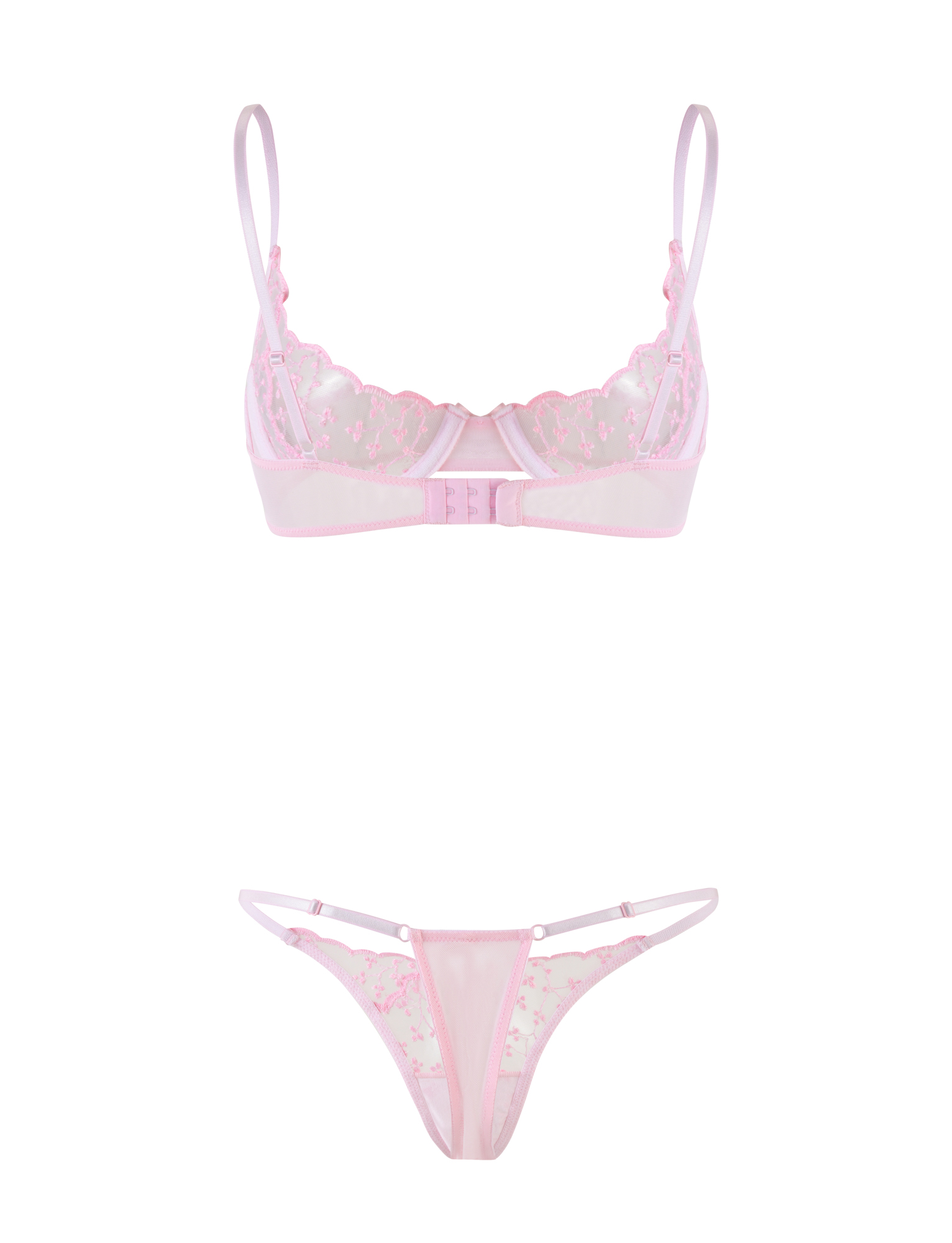 The TIGERMIST TALIYAH SET - PINK is a baby pink lingerie set with embroidered mesh floral details, featuring a sheer underwire bra with adjustable straps and a matching sheer thong for a feminine touch.