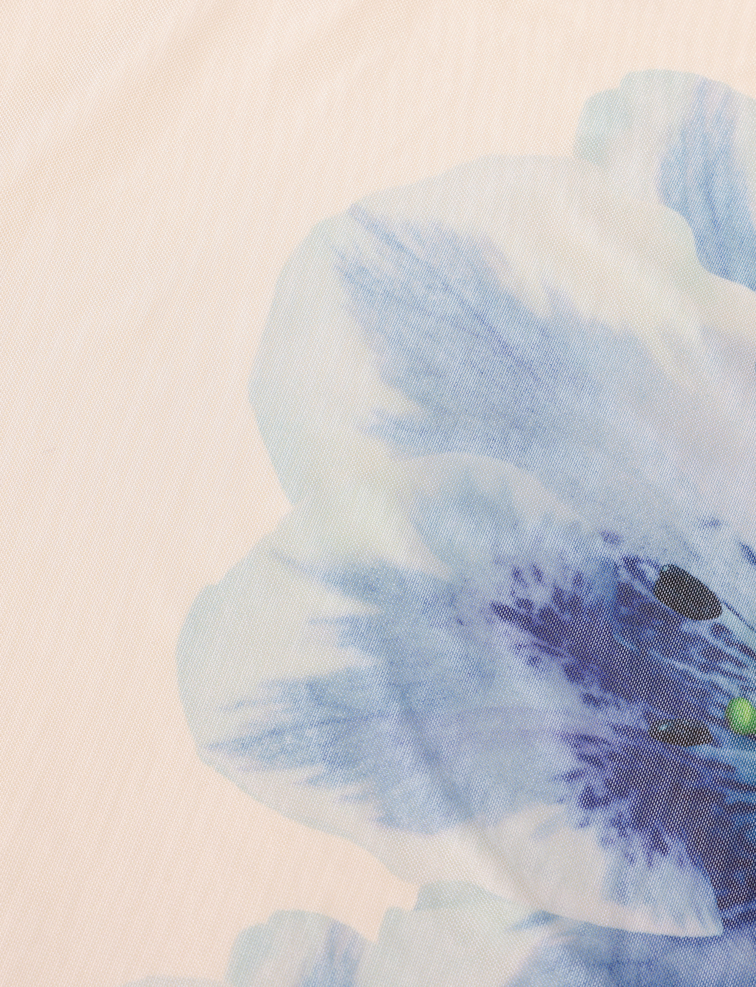 A close-up of the TIGERMIST LILLIAN SKIRT in cream shows a soft pastel hue with blue watercolor-style floral prints and purple details on a pale background.